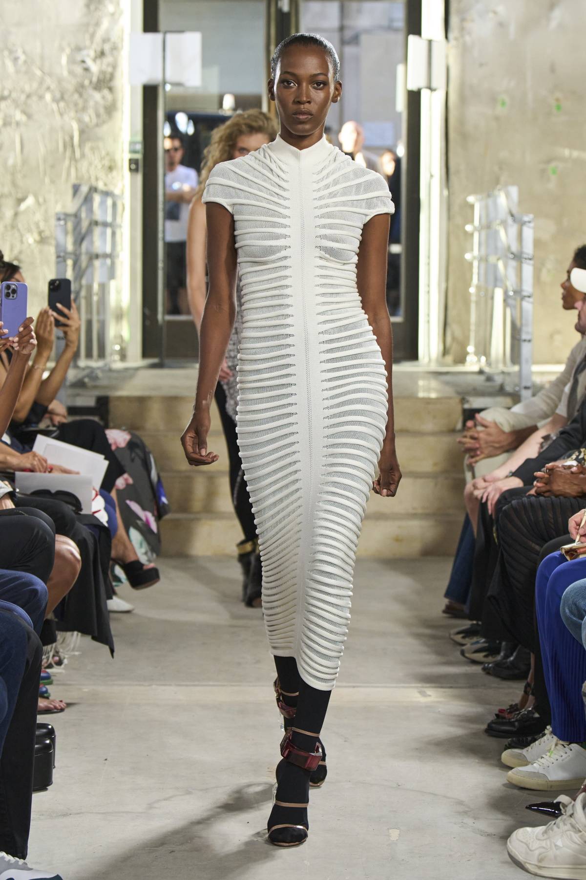 Kendall Jenner w białej sukience bodycon Alaïa. Bandażowe sukienki Hervé Léger były znakiem rozpoznawczym Kim Kardashian w połowie lat 2000. Teraz do trendu powraca jej siostra, Kendall Jenner. Pokaz kolekcji Alaïa wiosna-lato 2023.